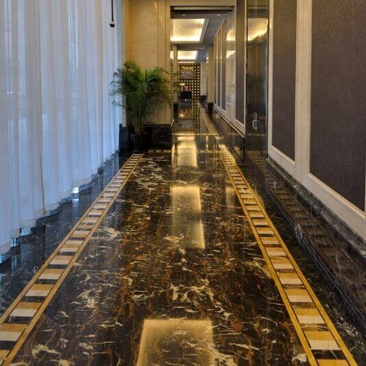 Black and gold marble floor combined with cream and yelow marble